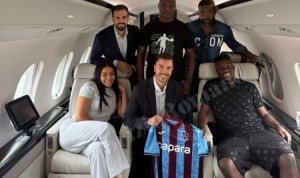 奥纳纳与家人、经纪人在飞机上合影，展示特拉布宗体育球衣